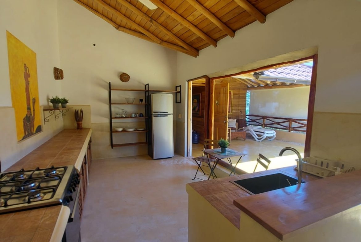 Cocina rústica con techo de madera y terraza