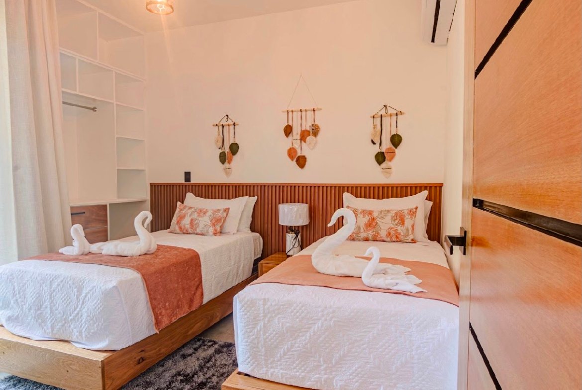 Dormitorio con dos camas individuales y decoración cálida