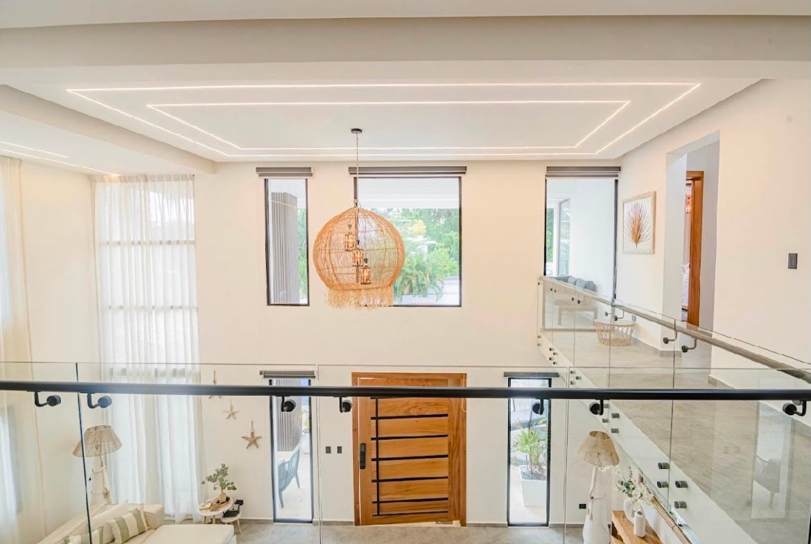 Salón moderno de doble altura con lámpara colgante