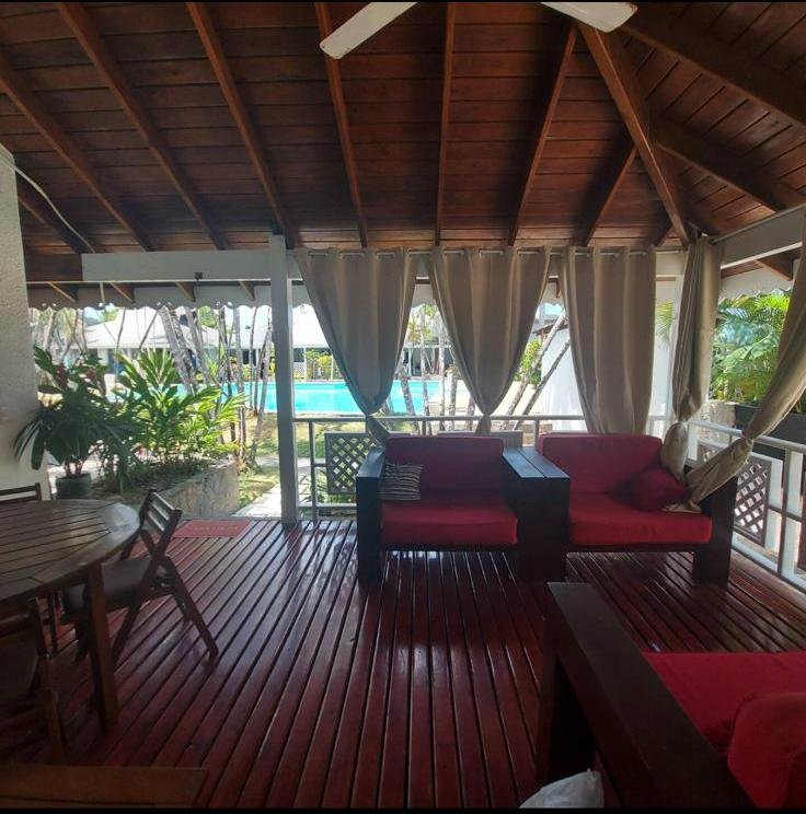 Terraza cubierta de madera con vistas a piscina