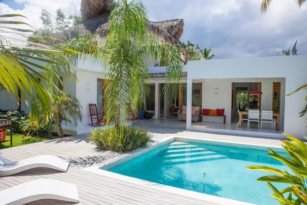 Villa moderna con piscina y jardín tropical