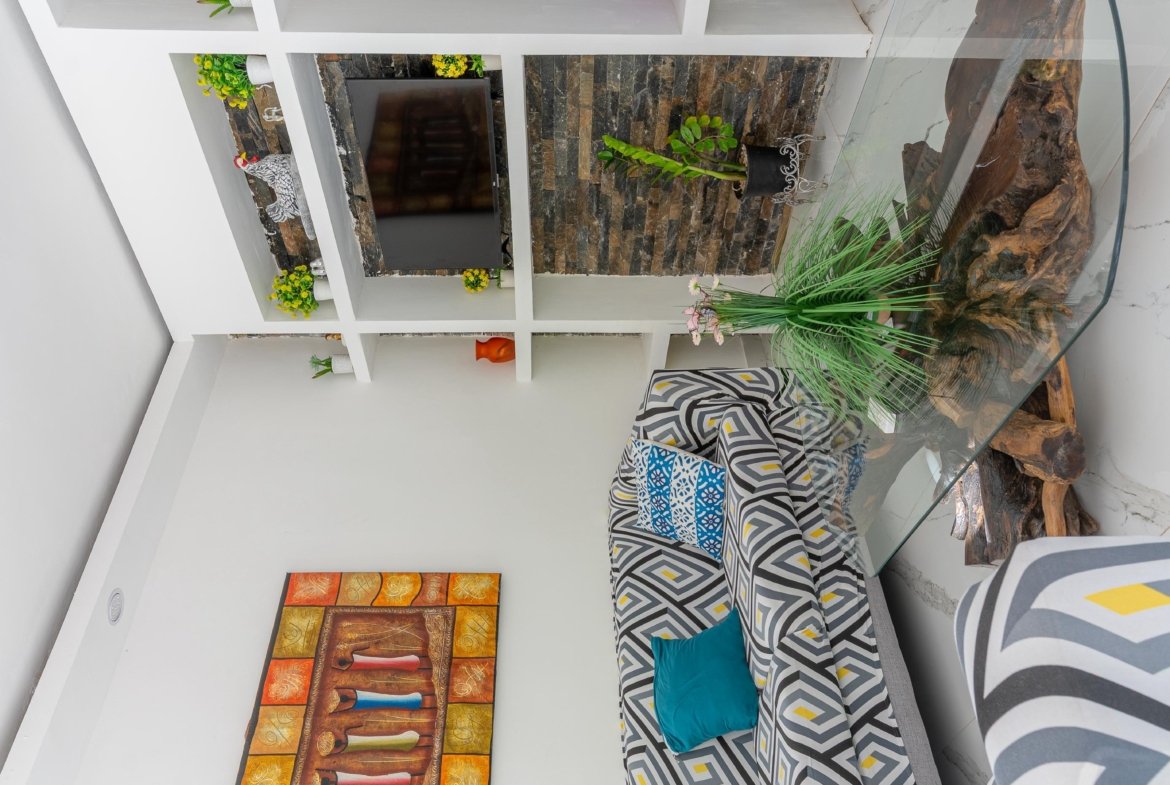 Salón moderno con sofá geométrico y pared de piedra