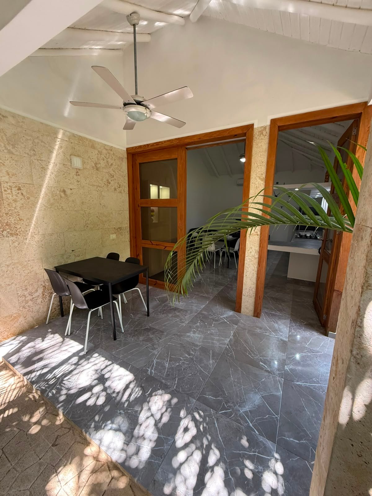 Terraza cubierta con mesa y sillas modernas